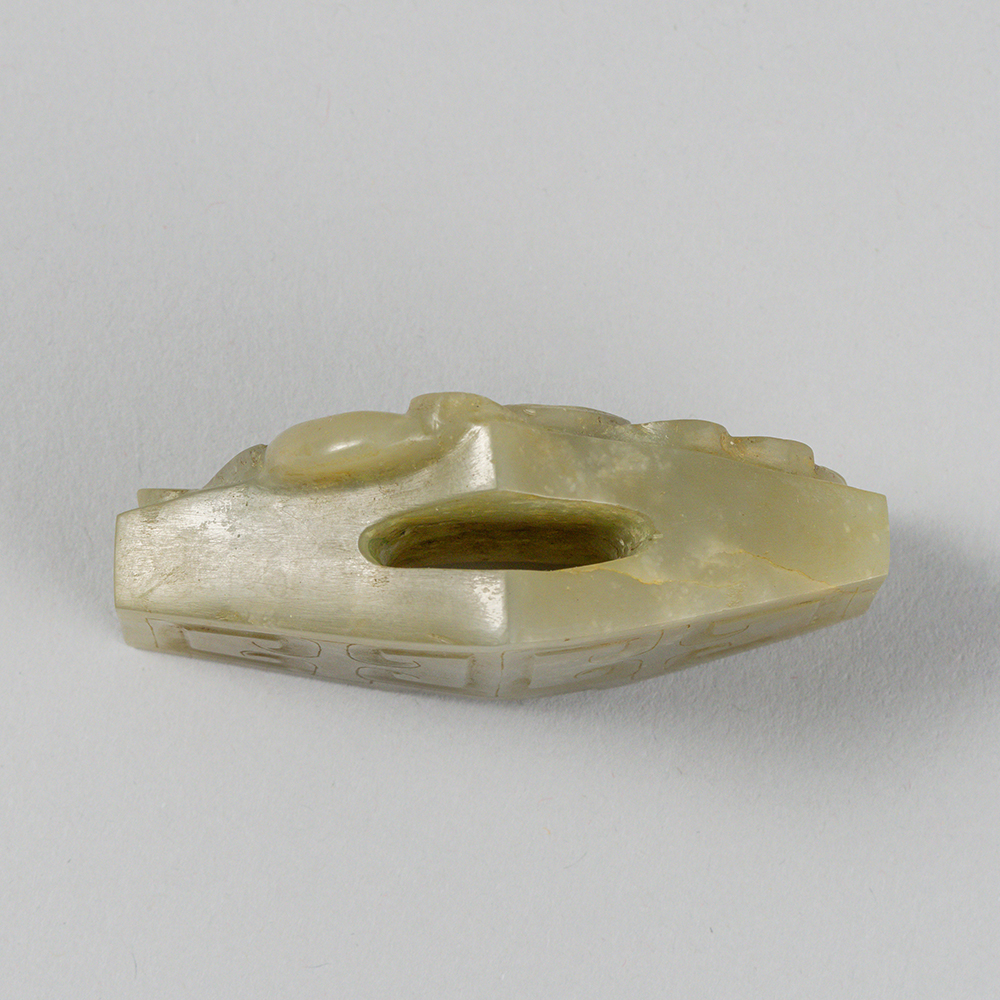 Lot2015 A CELADON JADE SWORD GUARD, WESTERN HAN DYNASTY Western Han Dynasty 2nd century BC to 1st century AD(서한 BC2세기 – AD 1세기)